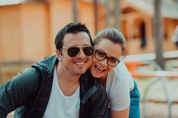 A romantic couple spending time in the park. A couple taking photo on a beautiful sunny day while having a weekend off