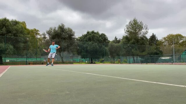 Tennis Player Hits The Ball And Expresses Achievement For Scoring