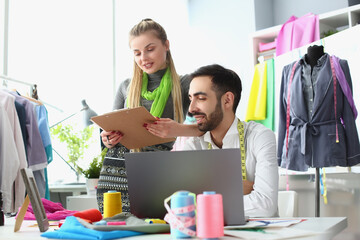 Seamstress consults with textile stylist for new collection