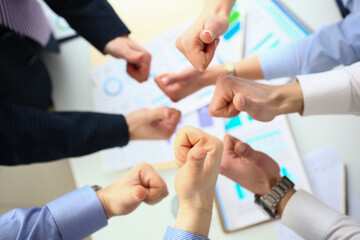 Closeup of business people hands showing thumbs up top view