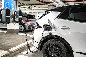 Recharging electric cars at the charging station in the underground parking. The concept of...
