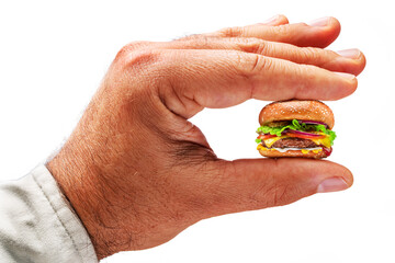 Diet concept - small cheeseburger in male hand isolated on white background.