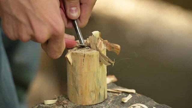 Using flint and steel to light a campfire