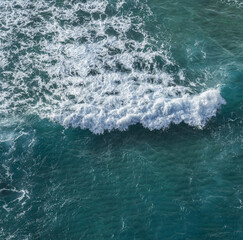 Ocean foamy pattern on ocean water surface. Top view.