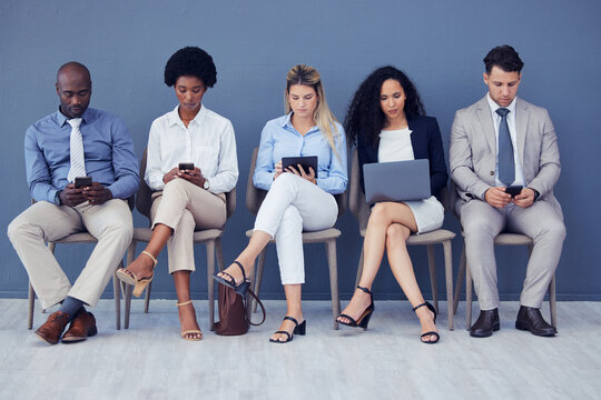 HR, technology and business people waiting in line for an interview during the recruitment process. Resume, diversity or hiring with a man and woman employee group sitting in a human resources row