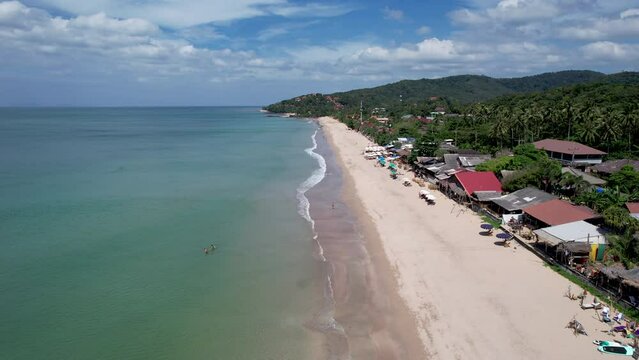 Forward reveal aerial footage of Lanta Klong Nin beach on sunny day. Ko Lanta, Krabi Province, Thailand.