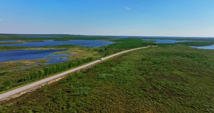 Drone shot following a motorhome driving in boreal nature, summer day in Kaldoaivi wilderness area, Finland