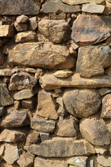 Archaeological background. Stone wall. Vertical photo.