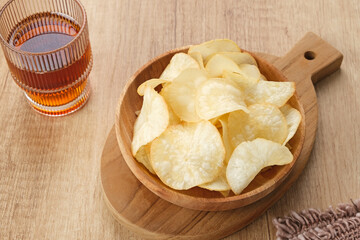 Keripik Singkong or Cassava Chips, Indonesian traditional snack. Served in bowl on wooden...