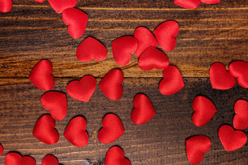 red fabric hearts on wood background