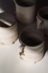 Obraz na płótnie Canvas Raw unfinished ceramic cups on the table