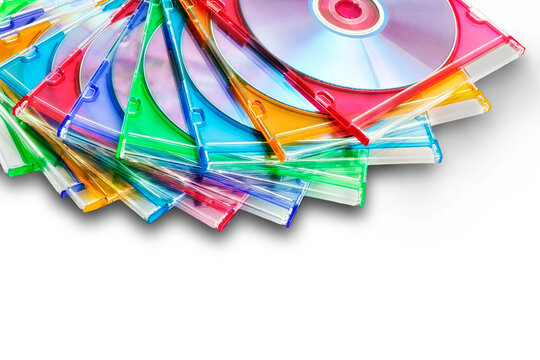 colorful CDs in boxes stacked in a pile on a white background