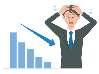 下降するグラフと頭を抱えるビジネスマン