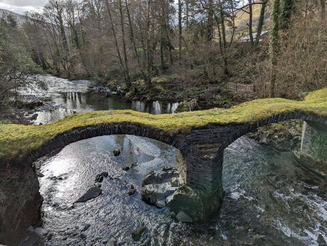 A view of the ancient Pont Minllyn or packhorse bridge that crosses the river Dyfi at Mallwyd, Gwynedd, Wales, UK.
