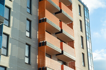 facade of the building with multi-colored balconies against the blue sky