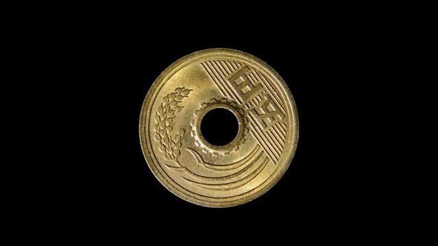 Reverse of Japan coin 5 yen 2004 with inscription meaning FIVE YEN, isolated in black background. 4k video