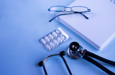 Doctor's set: a notebook for recording patient complaints, a fanendoscope, glasses and pills and...