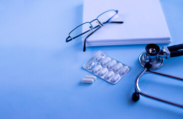 Doctor's set: a notebook for recording patient complaints, a fanendoscope, glasses and pills and...