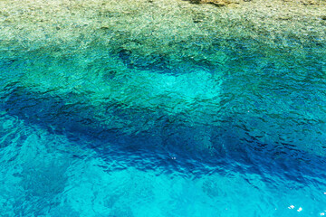 Azure ripples of shiny surface. Rippled shoal reflect of waters.Heavy sea seashore depth for background. Sunny liquid smooth сlean blink tide seaside. Deep vivid blue vintage relax beach view for swim
