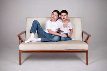 two brothers sitting in white t-shrt