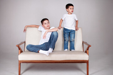 two brothers sitting in white t-shrt