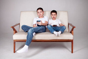 two boys in white t-shirt and jeans 