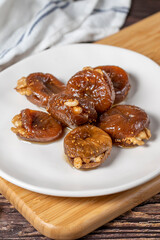 Walnut stuffed figs. Traditional Turkish sweets. Fig dessert with sherbet and walnuts. Close up