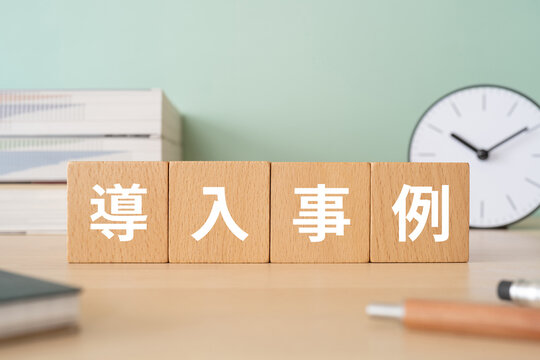 導入事例と書かれたブロックが置かれたデスク
