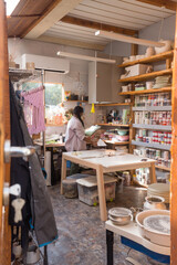 Woman with braided hair at her home art studio