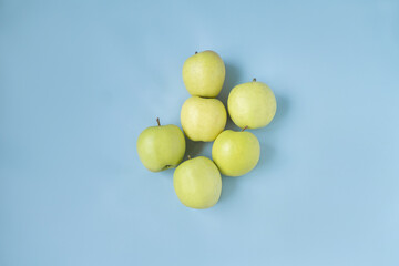 yellow and green apples on a blue background