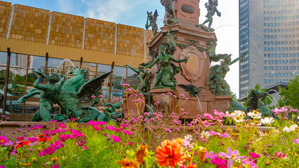 Leipzig, Germany, view over multiple colorful flowers and fountain in the historical downtown and...