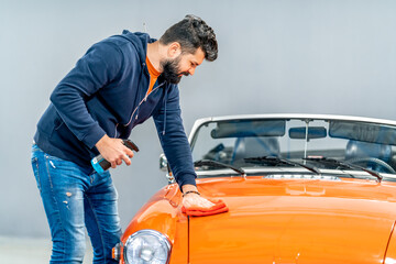manual cleaning and treatment of the body of a sports historic convertible