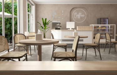 Blank wooden table counter in modern, luxury brown tropical design cafe, coffee table, rattan chair in sunlight from glass window to outdoor garden on beige wall. Interior background 3D