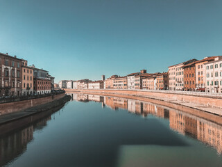 Fototapeta na wymiar River Arno in Florence and reflection of buildings in the water