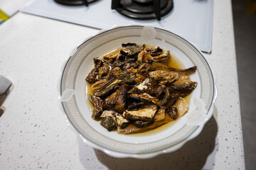 Plate of dried mushrooms soaked in water.