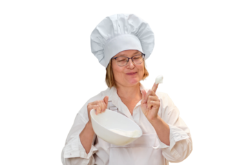 An adult woman in white chef's clothes cooks food in a home kitchen, isolated on a white background
