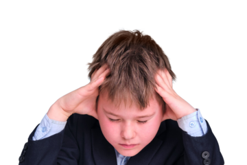 A sad boy in a school suit on distance learning, isolated on a white background