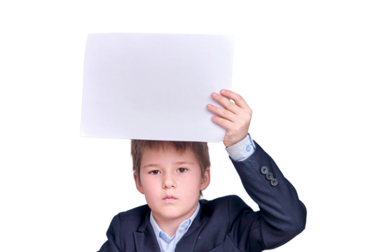 A boy in a school suit with a sheet of A4 paper during distance learning, isolated on a white background