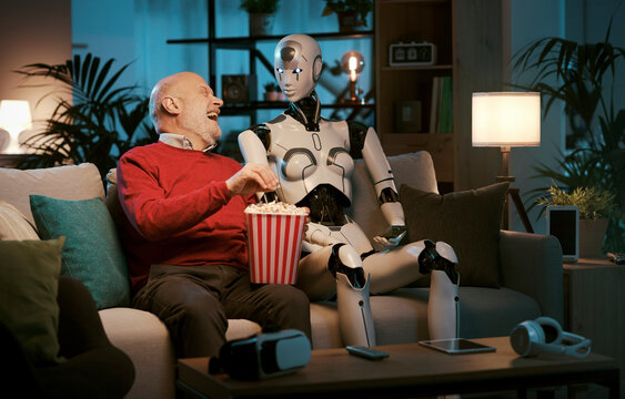 Senior man and female AI robot watching movies together at home