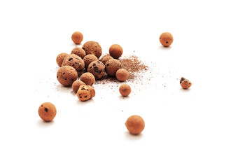 Expanded clay pebbles used as a growing media in hydroponics with sun light on white background