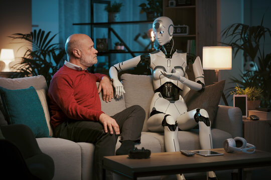 Senior man and AI robot talking together at home
