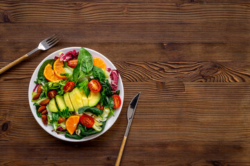 Bowl full of healthy vegetarian salad with avocado and tomatoes