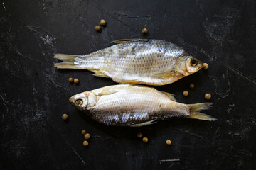dried salted fish on a black background. salted fish
