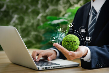 Businessman is using computer and holding ESG icon. Environment, Society and Governance. concept...