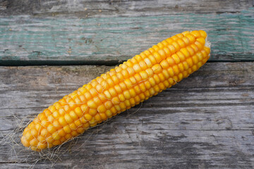 Fresh corn on wooden table, Top view close-up.