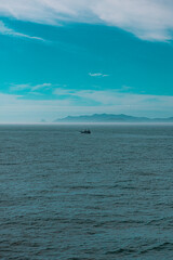 Fototapeta premium A boat floating in the middle an ocean, Jeju island, South Korea