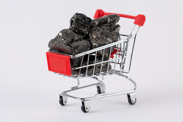 Grocery cart loaded with fossil coal, selling fuel.