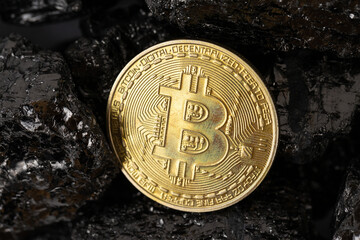 Mining bitcoin cryptocurrency on a pile of fossil fuels in the form of coal.