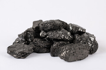 Heap of natural black fossil coal on a white isolated background.