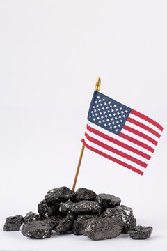 Heap of fossil coal selling fuel under american flag on white background.